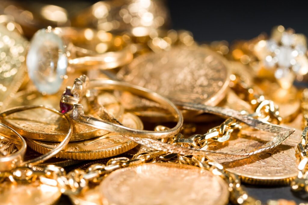 Jewels and gold coins over dark background